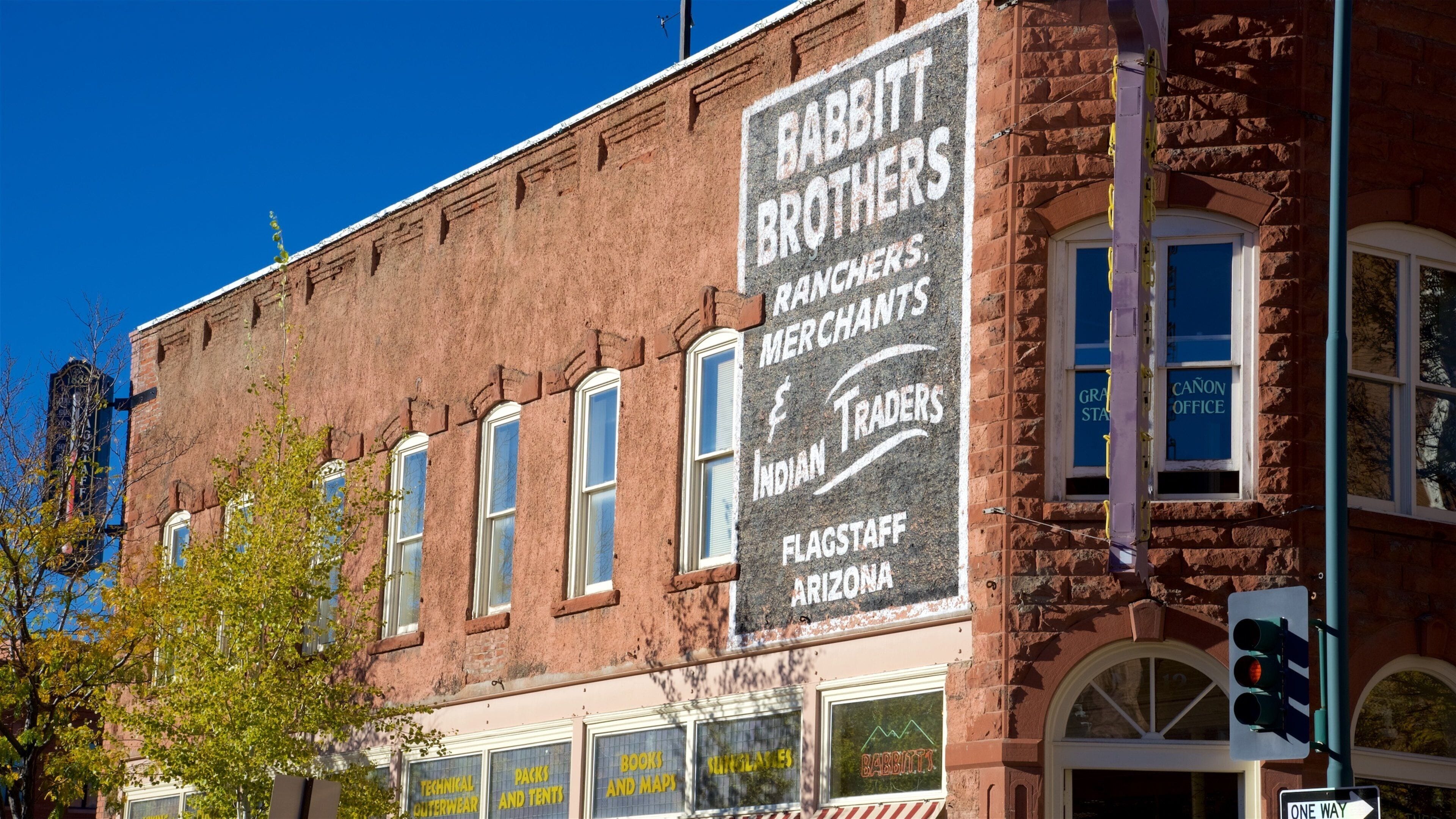 A brick building with a large sign advertising Babbitt Brothers, a flagstaff and flag store in Arizona.