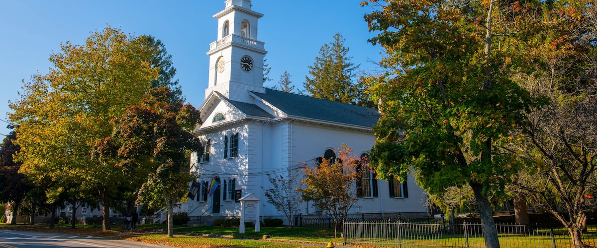 First Unitarian Church with fall foliage at 223 Main Street, in historic town center of Kingston, Massachusetts MA, USA.