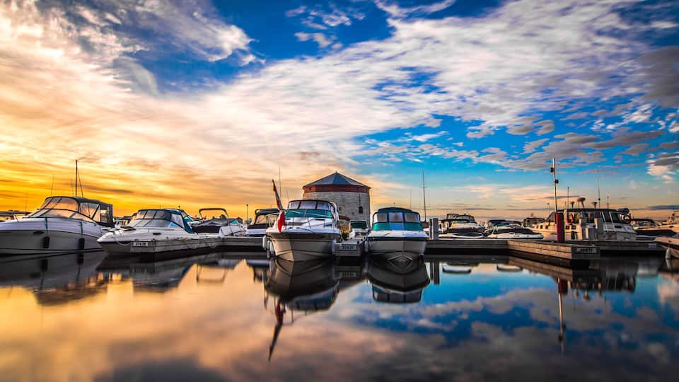 A marina with boats docked at sunset.