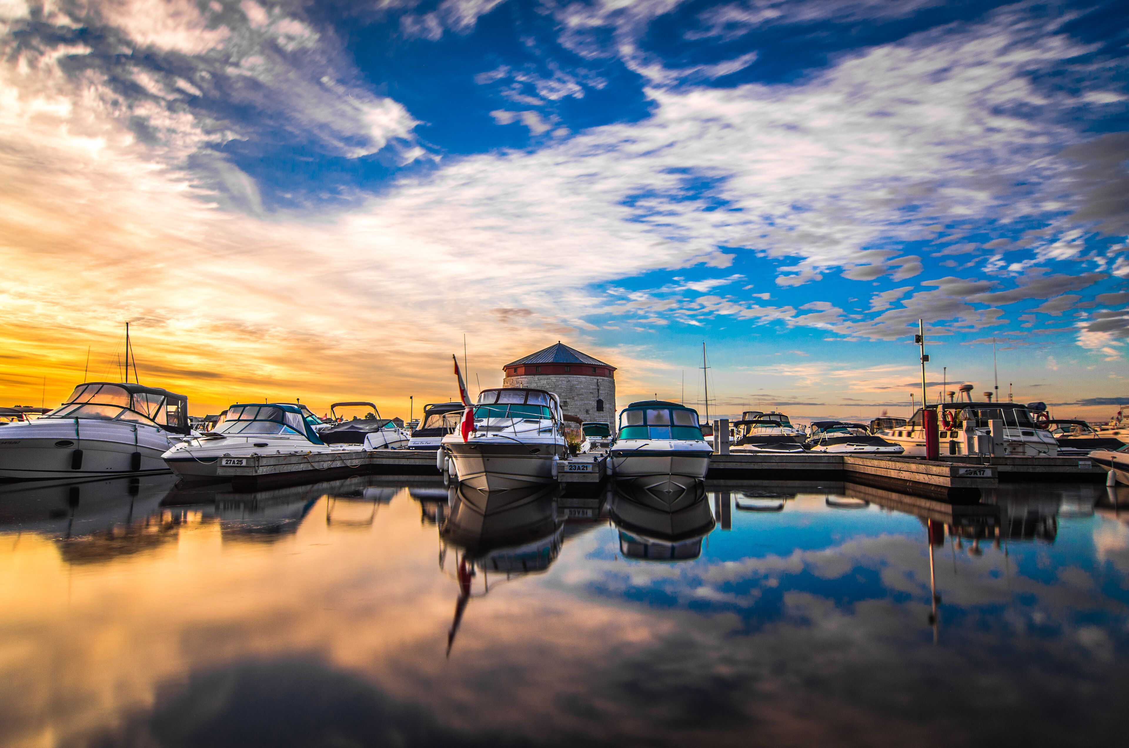 A marina with boats docked at sunset.