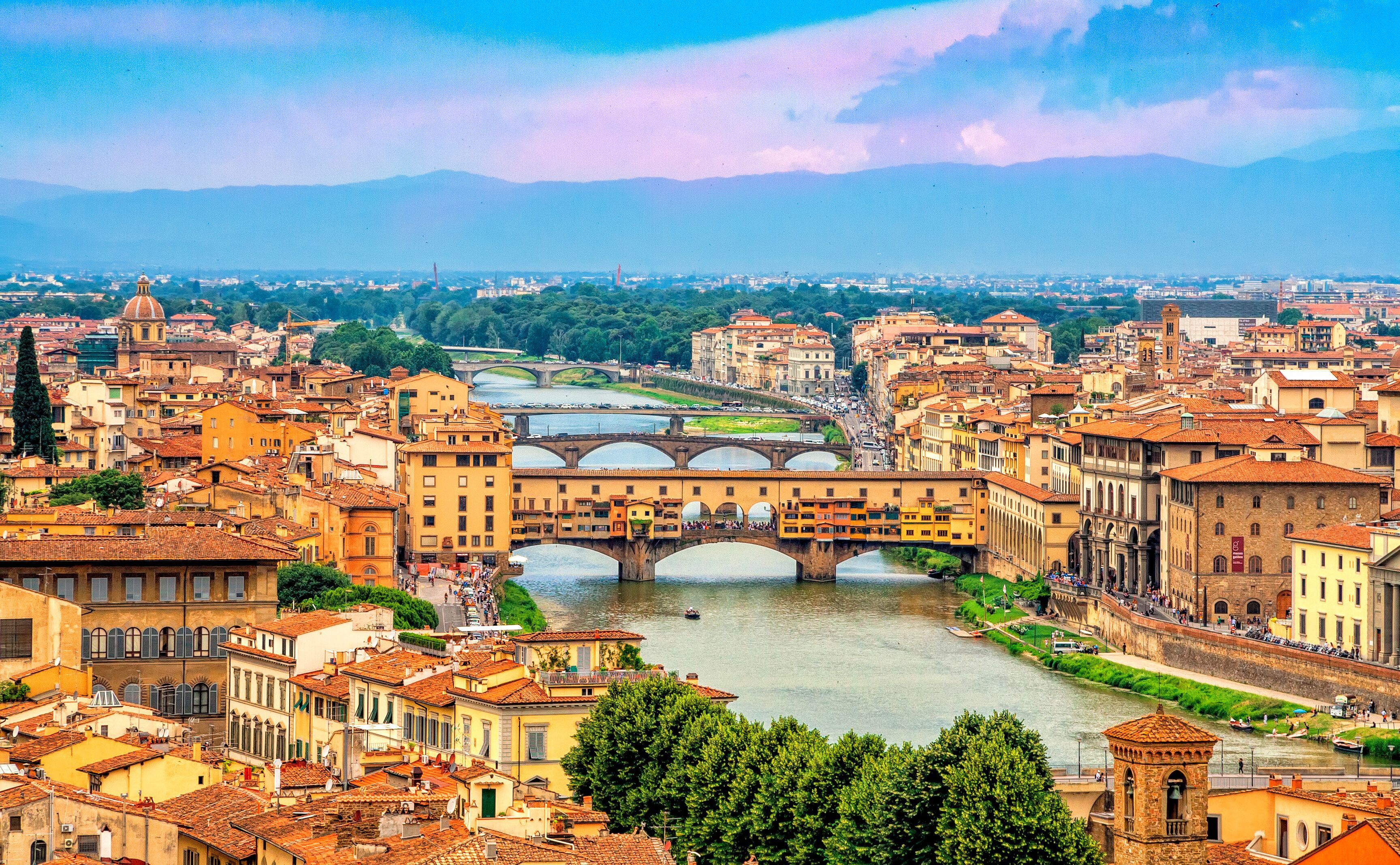 Panoramic view of medieval stone bridge Ponte Vecchio over Arno river in Florence (Firenze), Tuscany, Italy, Europe. Florence cityscape. Architecture and landmark of Florence and Italy