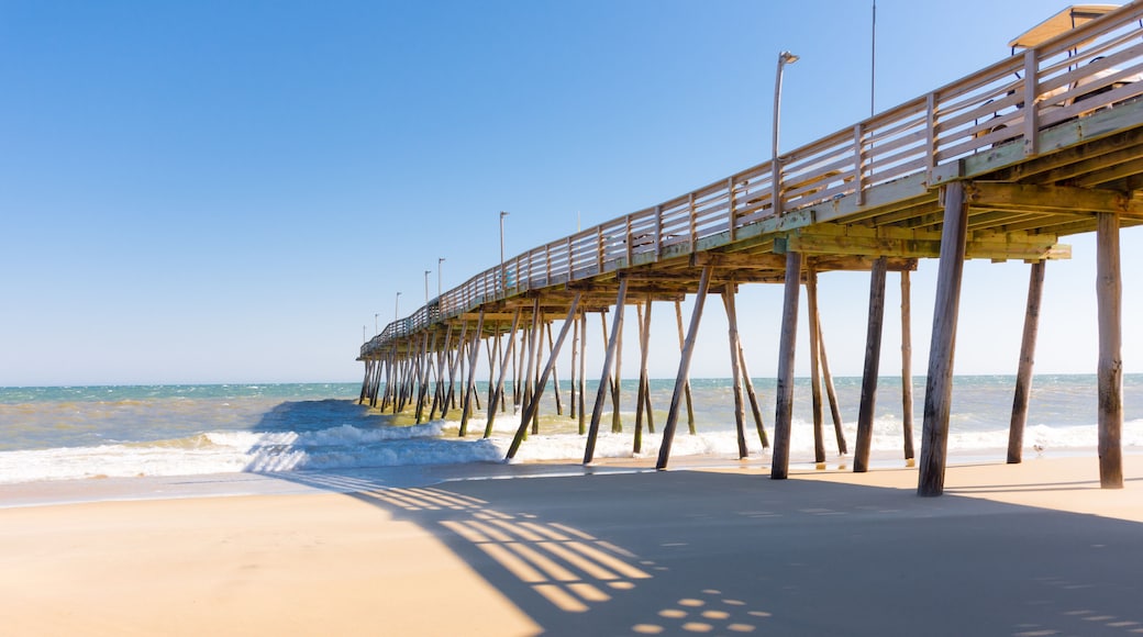 Kitty Hawk Pier in bright sunshine with shadows, ocean, and clear blue sky