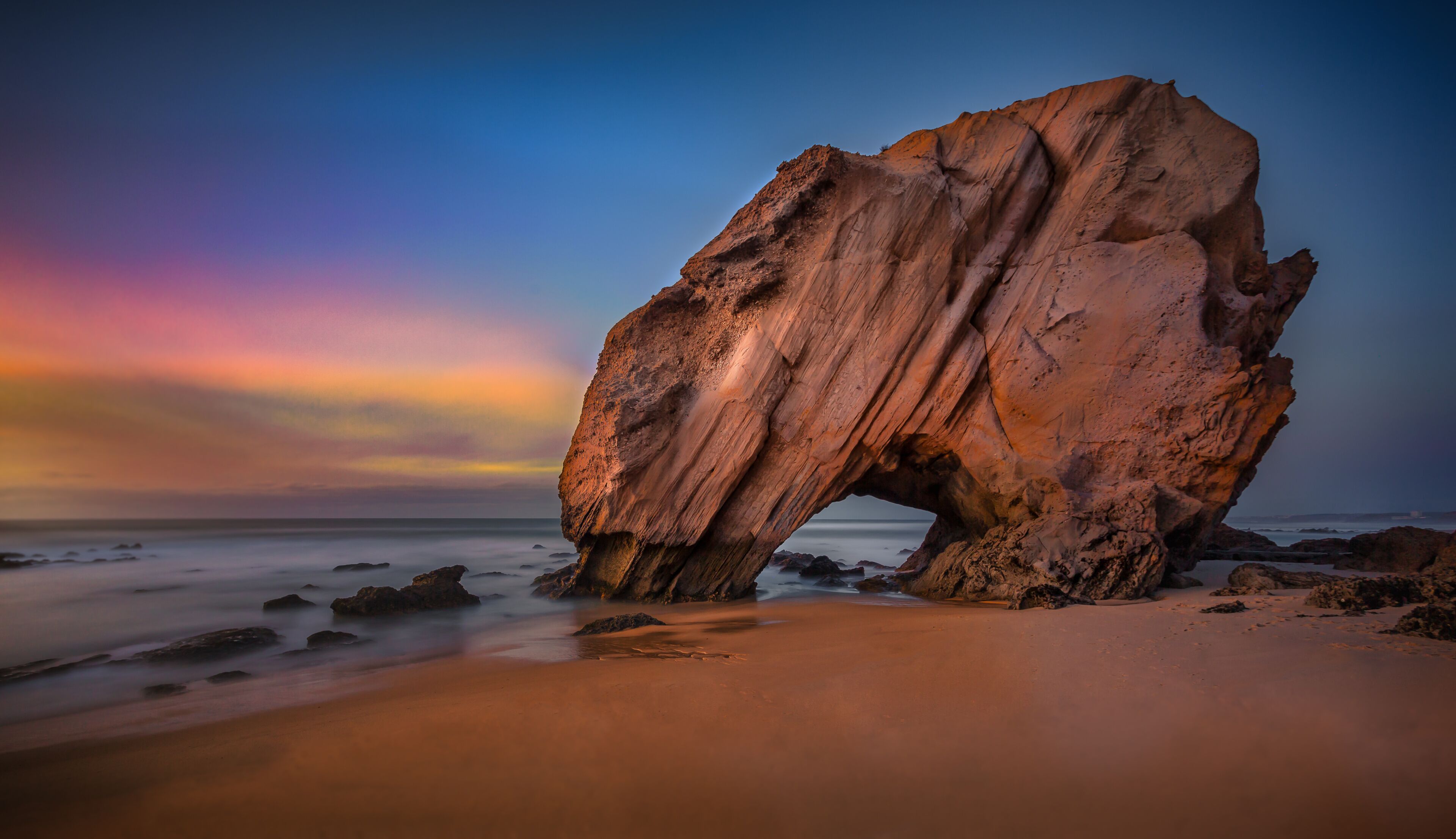 Penedo do Guincho. 143'' long exposure of this peculiar rock formation at sunset with low tide, located in the Santa Cruz beach, Portugal