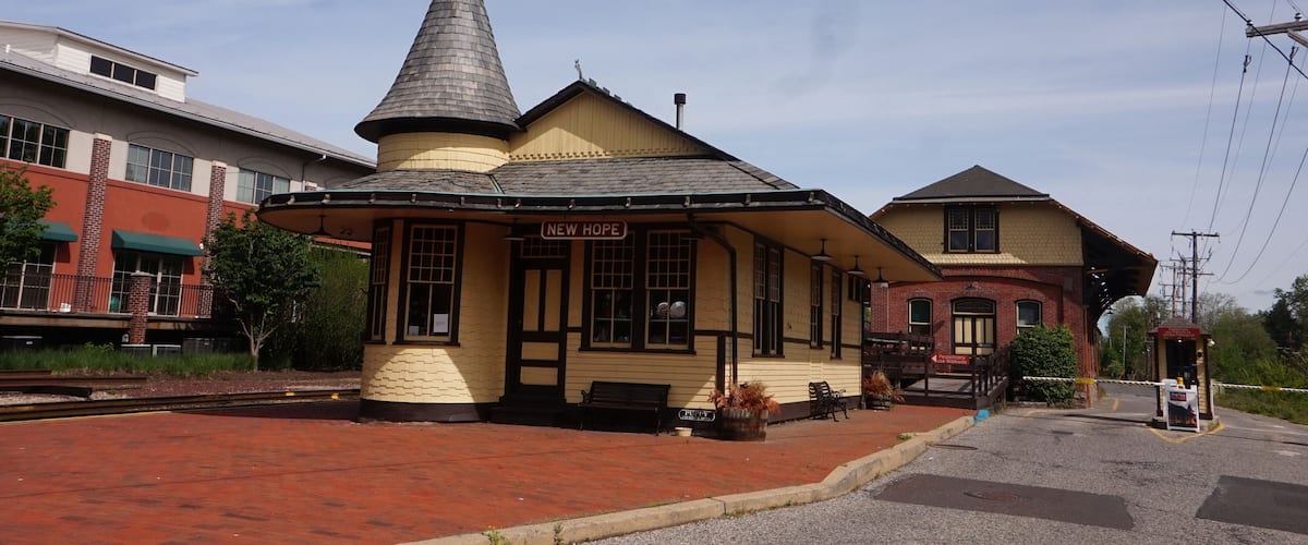 A small yellow building with a conical roof labeled "New Hope."