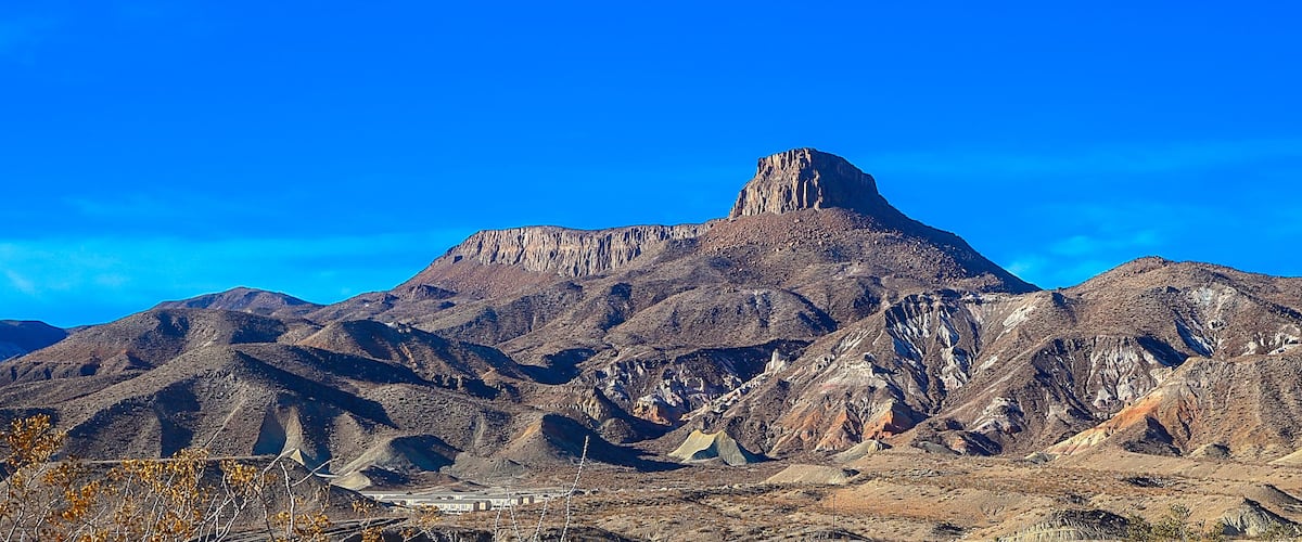A rugged mountain range with a prominent peak.