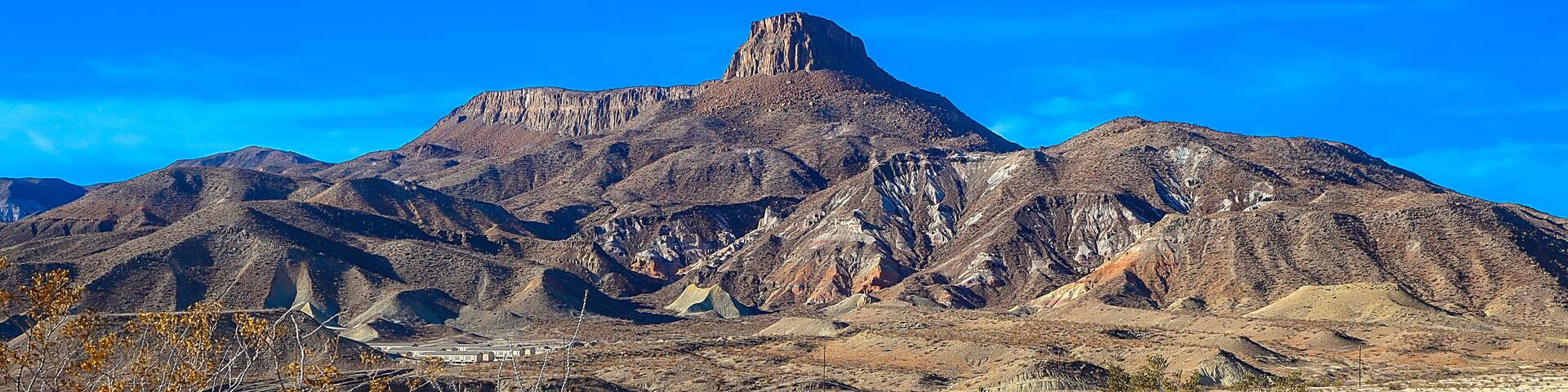 A rugged mountain range with a prominent peak.