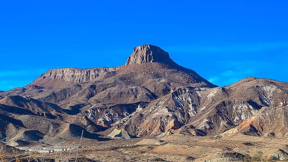 A rugged mountain range with a prominent peak.