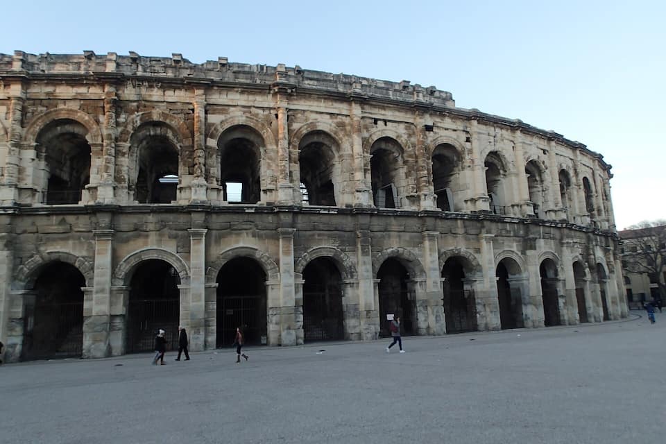An ancient amphitheater with multiple arches and columns.
