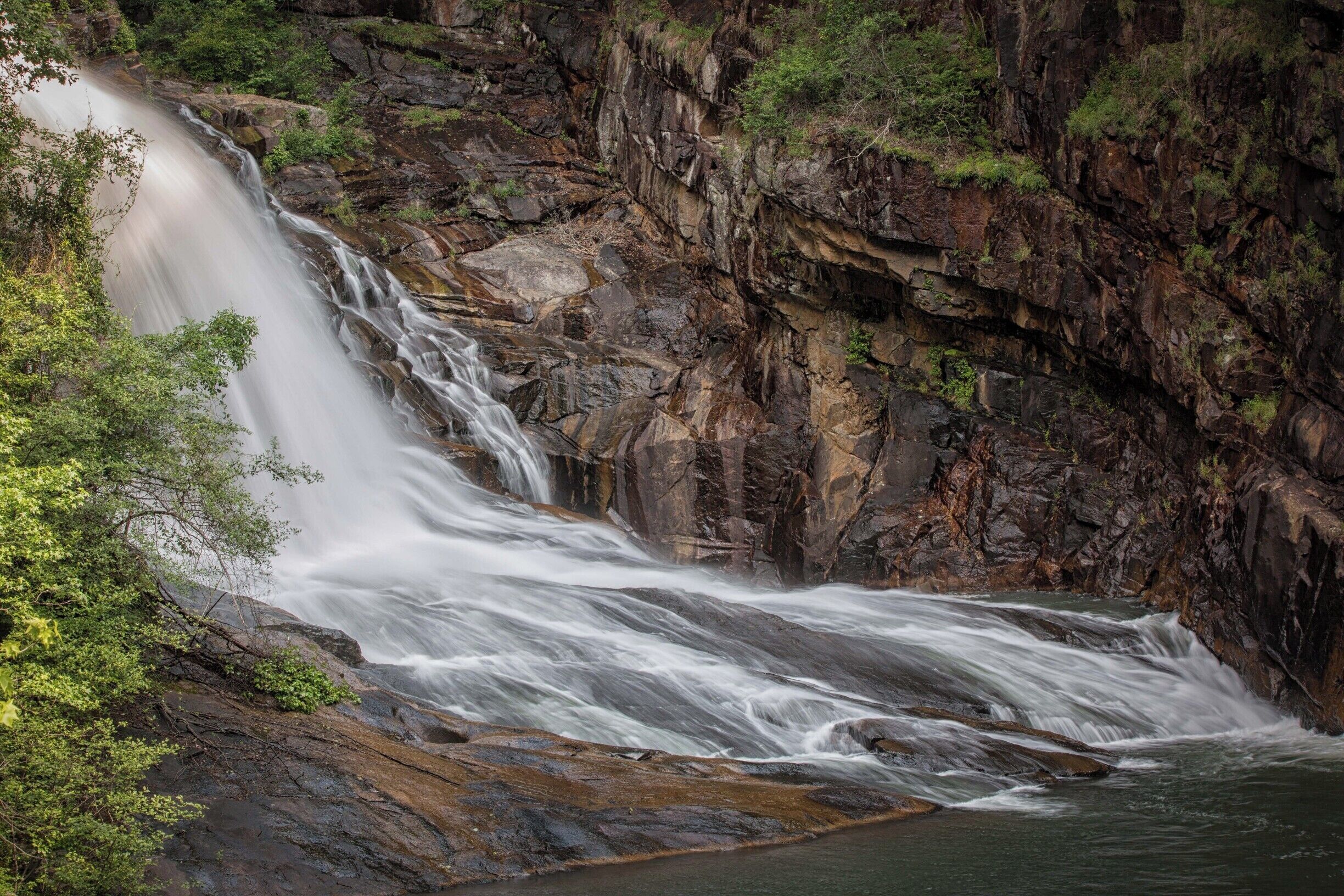 One of the most spectacular spots in north Georgia is Tallulah Gorge with its mile long series of waterfalls and pools. The climb down to the gorge is a steep set of stairs to a viewing platform where you can see this fall at a angle. If you want to see more of the gorge, you must follow a trail along the river on what is more of a rock climb than a hike.  Not recommended unless you are used to rugged hikes. 