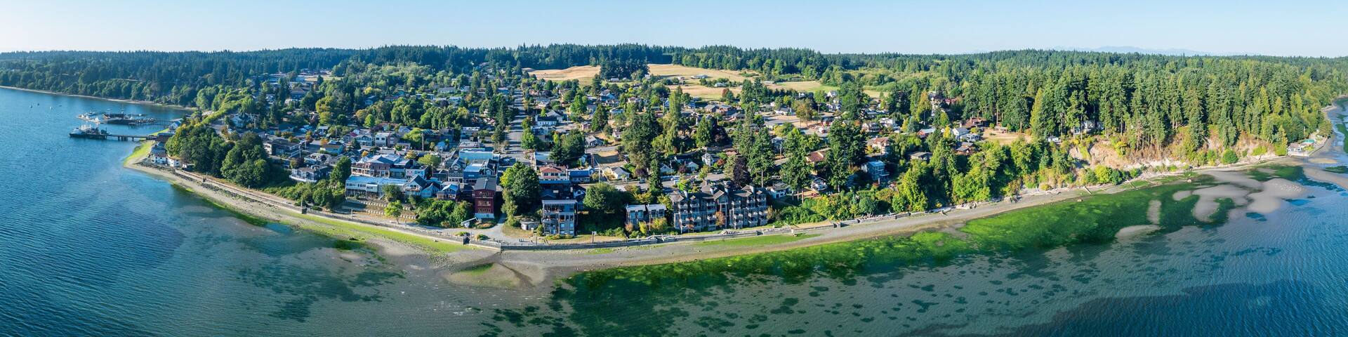 Breathtaking aerial view of resort town of Langley on Whidbey Island, Washington with clear skies and calm waters