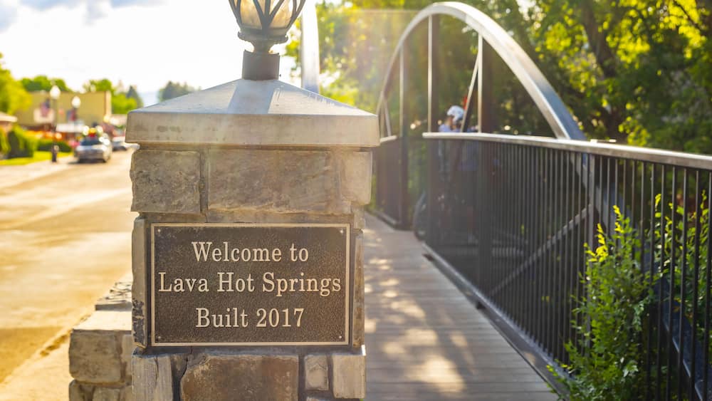 A stone sign with the text 'Welcome to Lava Hot Springs Built 2017' on a bridge.