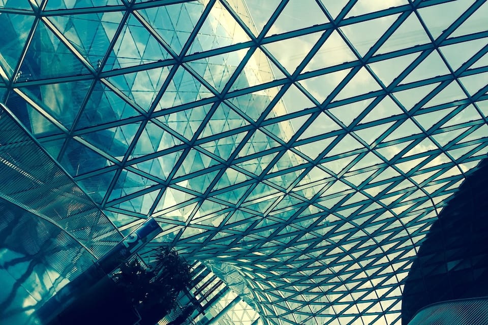 A modern glass structure with a geometric pattern.
