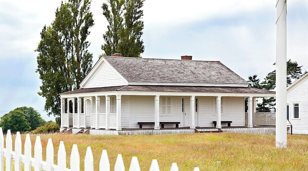 Only three buildings remain from the military camp that was located here for 14 years starting in 1859. Generally speaking, the buildings weren't built to last, so it's impressive that these have survived for more than 150 years.
The building pictured here was one of the officers' quarters. It was likely moved from Fort Bellingham in 1859 and occupied by Capt. George Pickett (of later Gettysburg fame). After the camp was disbanded in 1874 the building was auctioned off and converted into a farmhouse. It was later acquired by the National Park Service and restored to original condition.
The building next to it was the other officers' quarters. After the auction it was moved to downtown Friday Harbor and employed for over 130 years. In 2010 it too was acquired by the National Park Service, which moved it back to it's historic location.
You can read more about American Camp here: http://www.nps.gov/sajh/historyculture/upload/2012-American_Camp_History_Walk_online_color.pdf
