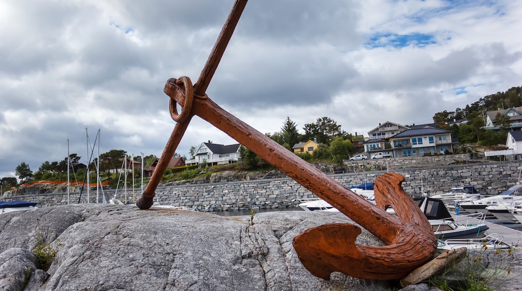 Huge rusty anchor on a pedestal on the banks of a fjord in Norway