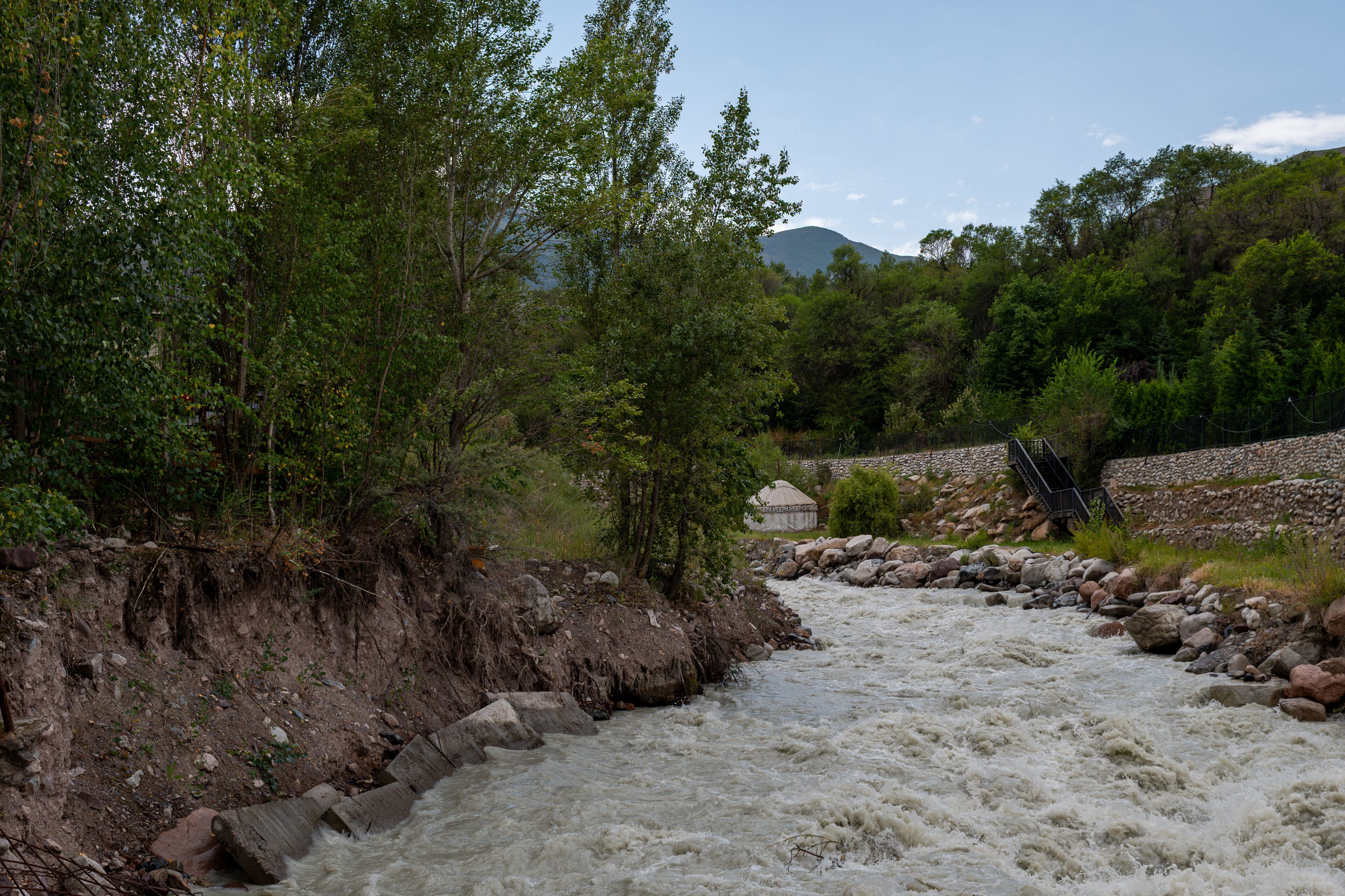 Mountain river and Kyrgyz yurt in Ala Archa, Kyrgyzstan.