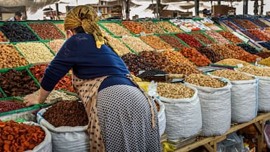 A market with various nuts and dried fruits displayed in bins and sacks.