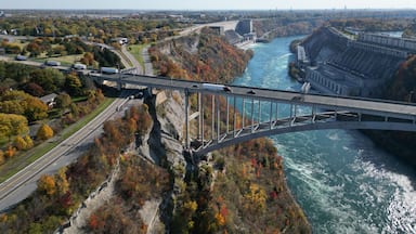 Aerial over the Niagara River and gorge, the international border crossing Queenston-Lewiston bridge between New York, United States and Ontario, Canada with hydroelectrical power plants, in autumn.
