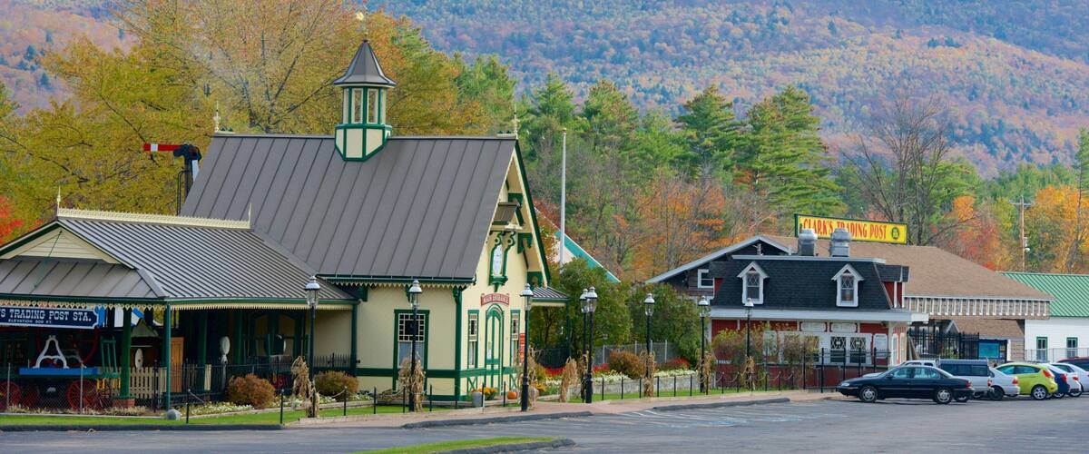 A small town with a post office, a church, and a mountain in the background.