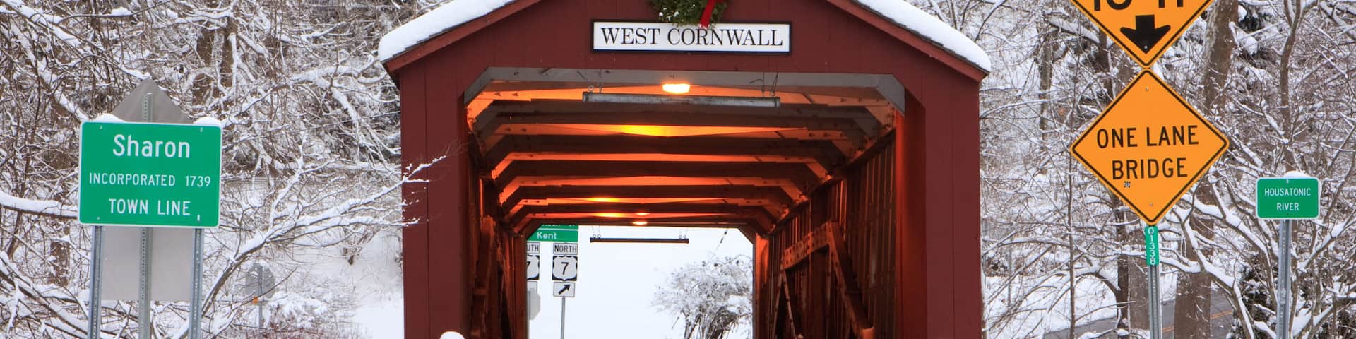 Covered bridge with a Christmas wreath in winter in West Cornwall, Connecticut