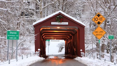 Covered bridge with a Christmas wreath in winter in West Cornwall, Connecticut