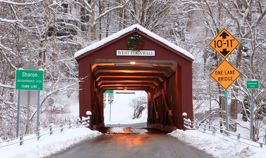 Covered bridge with a Christmas wreath in winter in West Cornwall, Connecticut