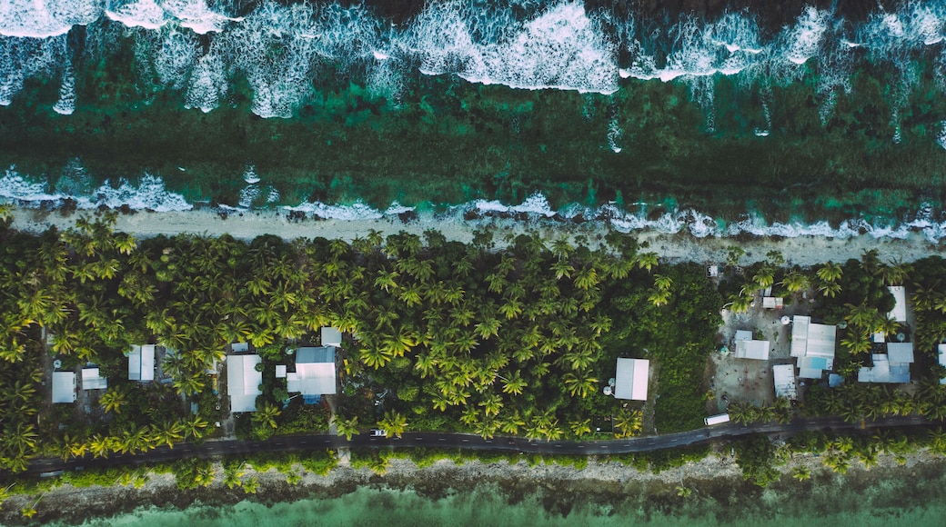 Tuvalu (Funafuti) aerial shot of one of the thinest part of the island where the ocean and lagoon can be seen together .