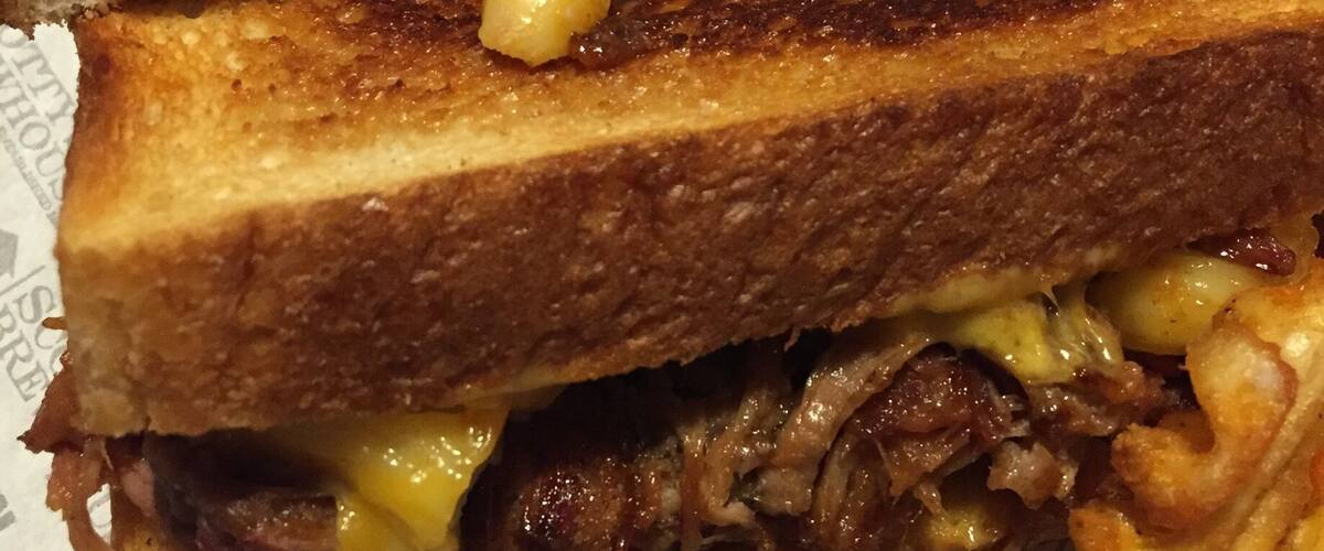 The "piggy mac grilled cheese" - cheddar and American cheeses, pulled pork, and Mac and cheese grilled cheese sandwich!