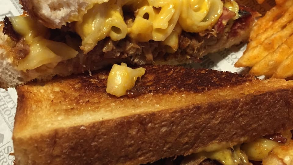 The "piggy mac grilled cheese" - cheddar and American cheeses, pulled pork, and Mac and cheese grilled cheese sandwich!