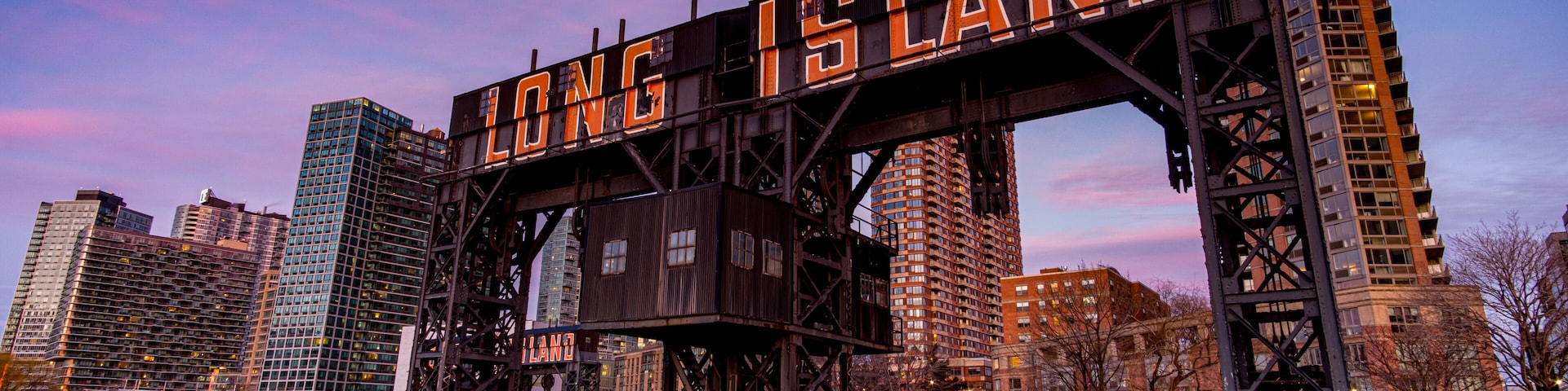 Sunset Pink Sky Over Long Island City Sign at Gantry Plaza State Park in Queens New York