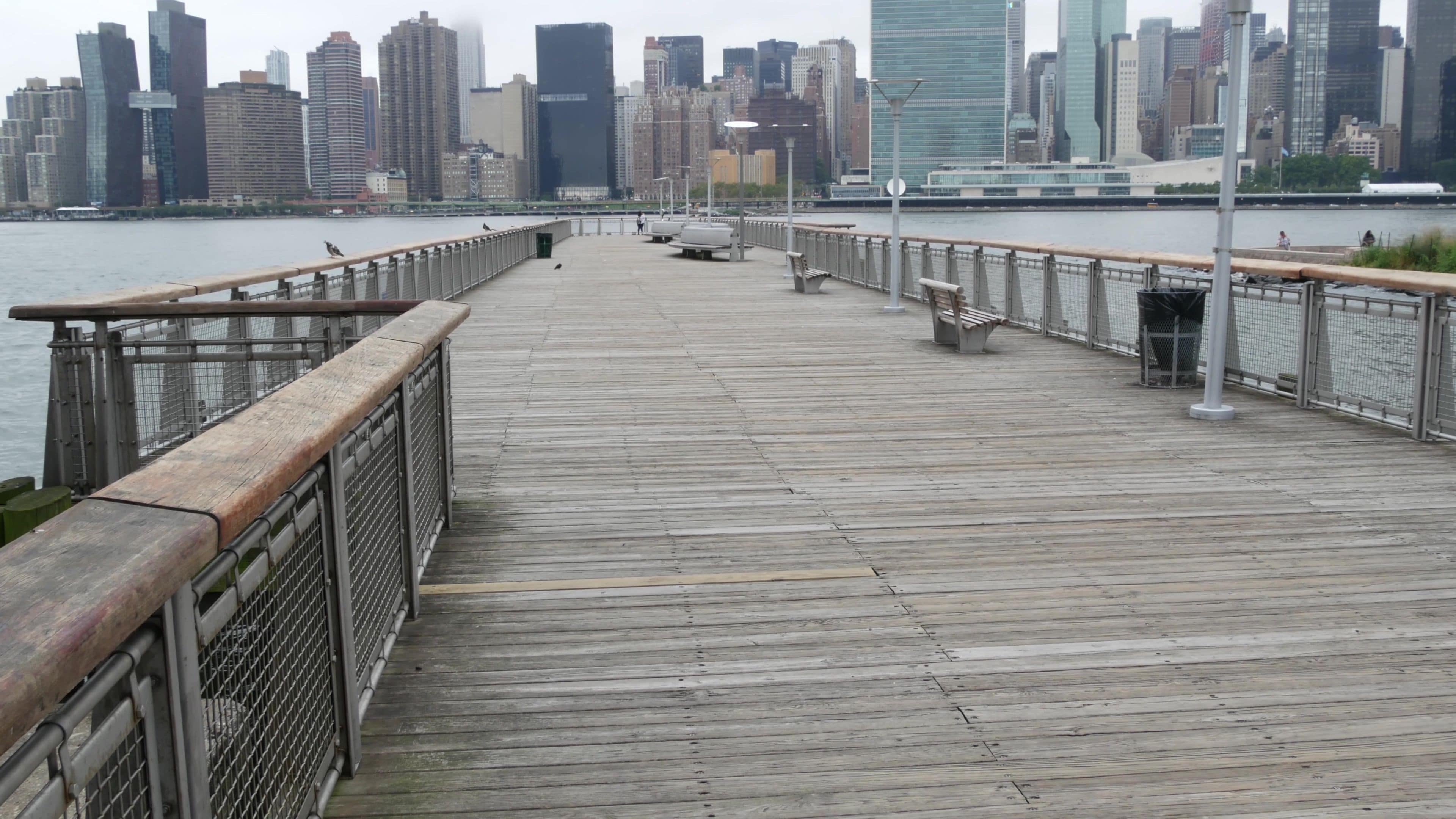 New York City waterfront skyline, Manhattan Midtown buildings, riverfront skyscrapers by East river water. Waterside cityscape view, Gantry Plaza pier, Long Island, Queens. United States architecture.
