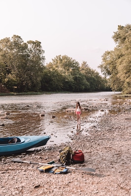 7 year old playing in the creek, summertime evening