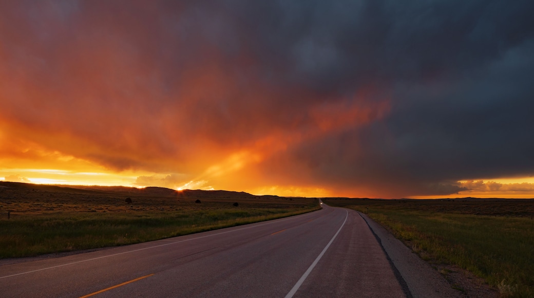 Sunset over highway 59 north of gillette, wyoming with storm clouds