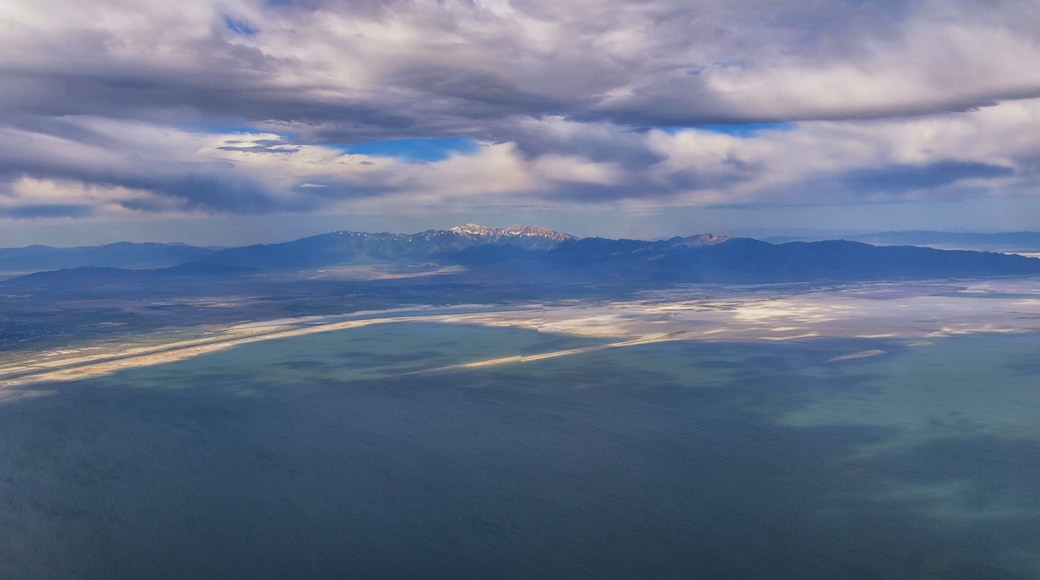Great Salt Lake Utah Aerial view from airplane looking toward Oquirrh Mountains and Antelope Island, Tooele, Magna, with sweeping cloudscape. United States.
