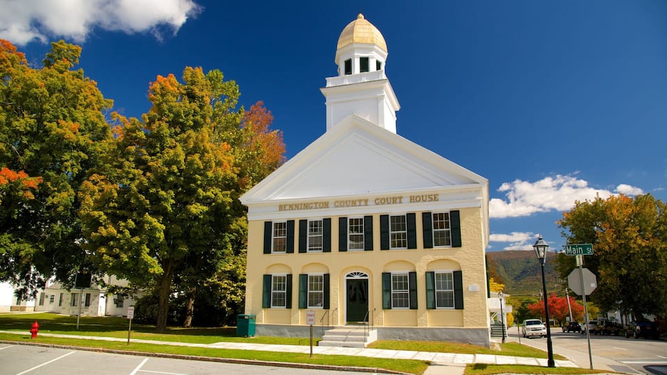 The Bennington County Court House with a white facade, green shutters, and a gold dome.