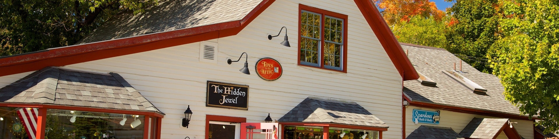 A white building with red trim and a sign that reads "The Hidden Jewel."