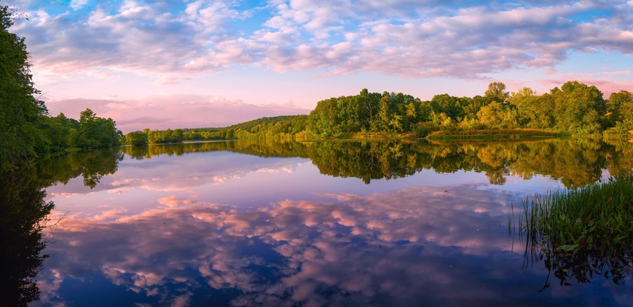 Tranquil Eagleville Pond autumn sunrise at the confluence of the Willimantic River and local brooks in Storrs, Connecticut—a public conservation haven for hiking, fishing, and paddling.