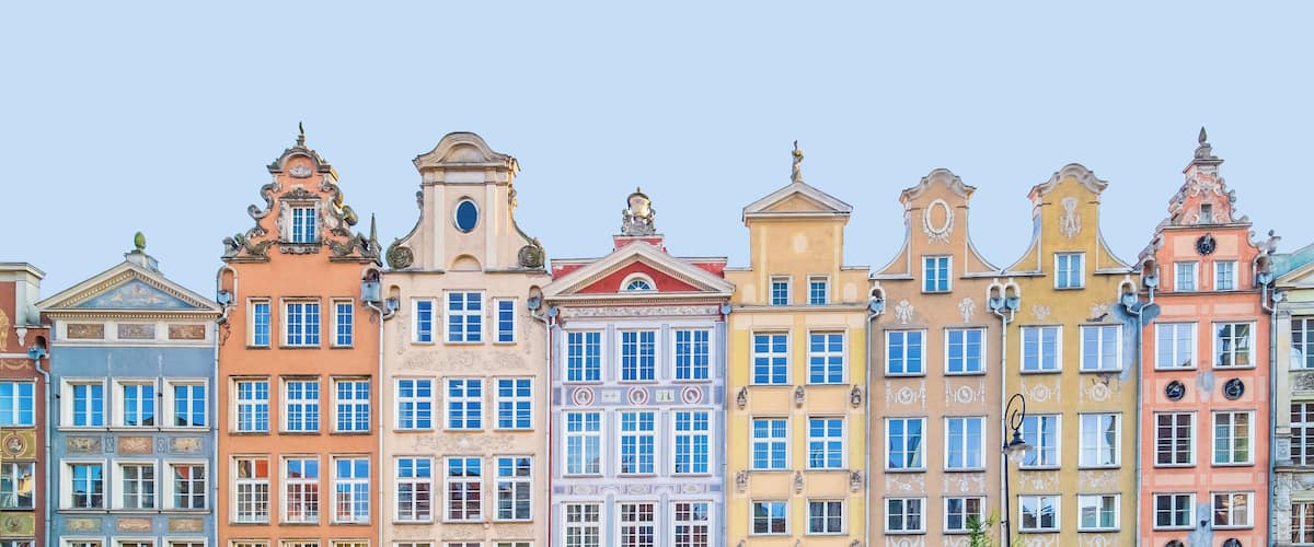 A row of colorful historic buildings with ornate facades and architectural details.
