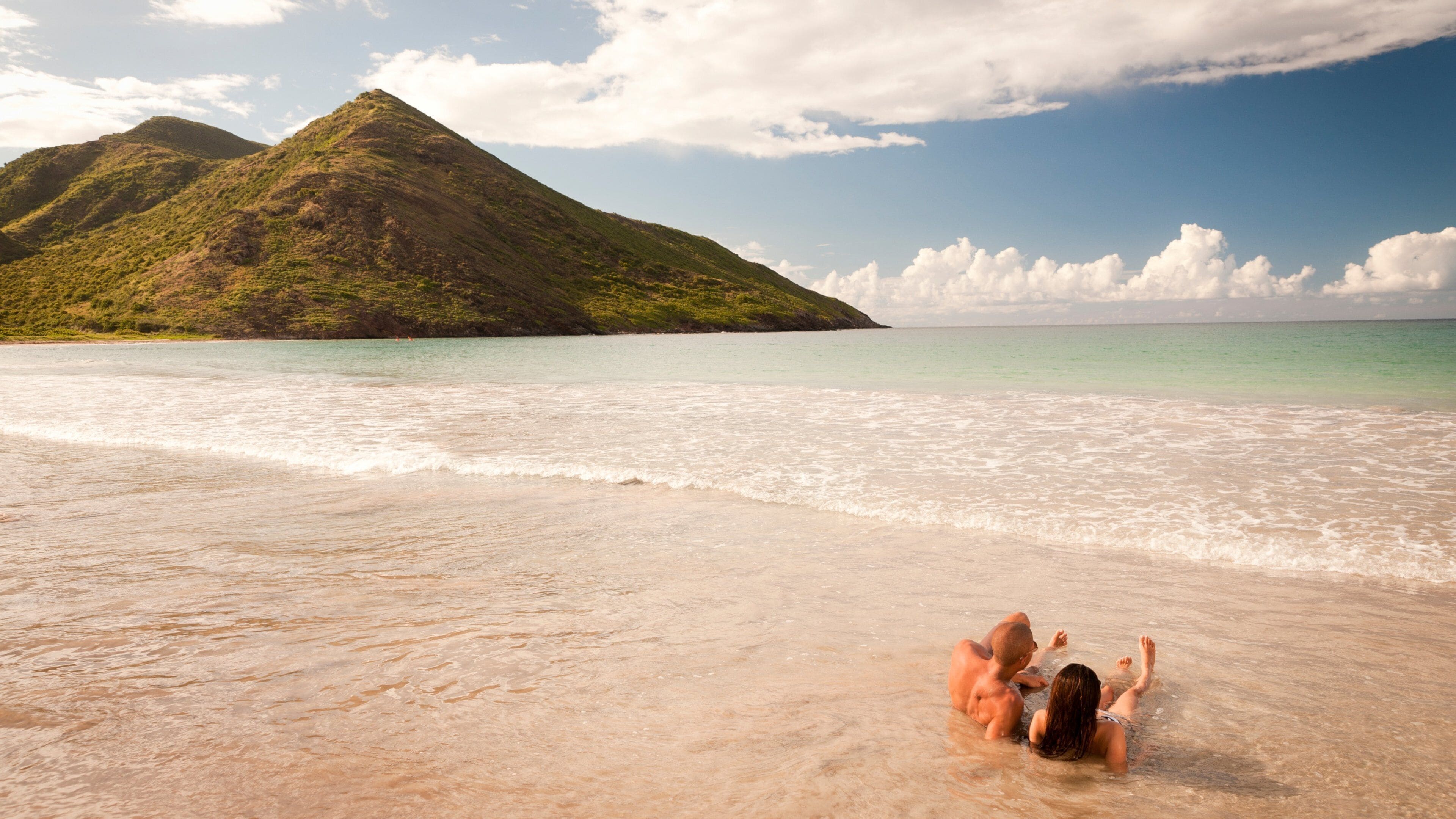 St. Kitts and Nevis which includes a beach, general coastal views and swimming