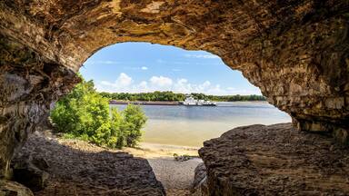 An Ohio River barge is viewed from Cave-In-Rock, a natural cavern and main attraction of its namesake Illinois state park. The cave, in a limestone bluff, is said to have been a pirates’ hideout.