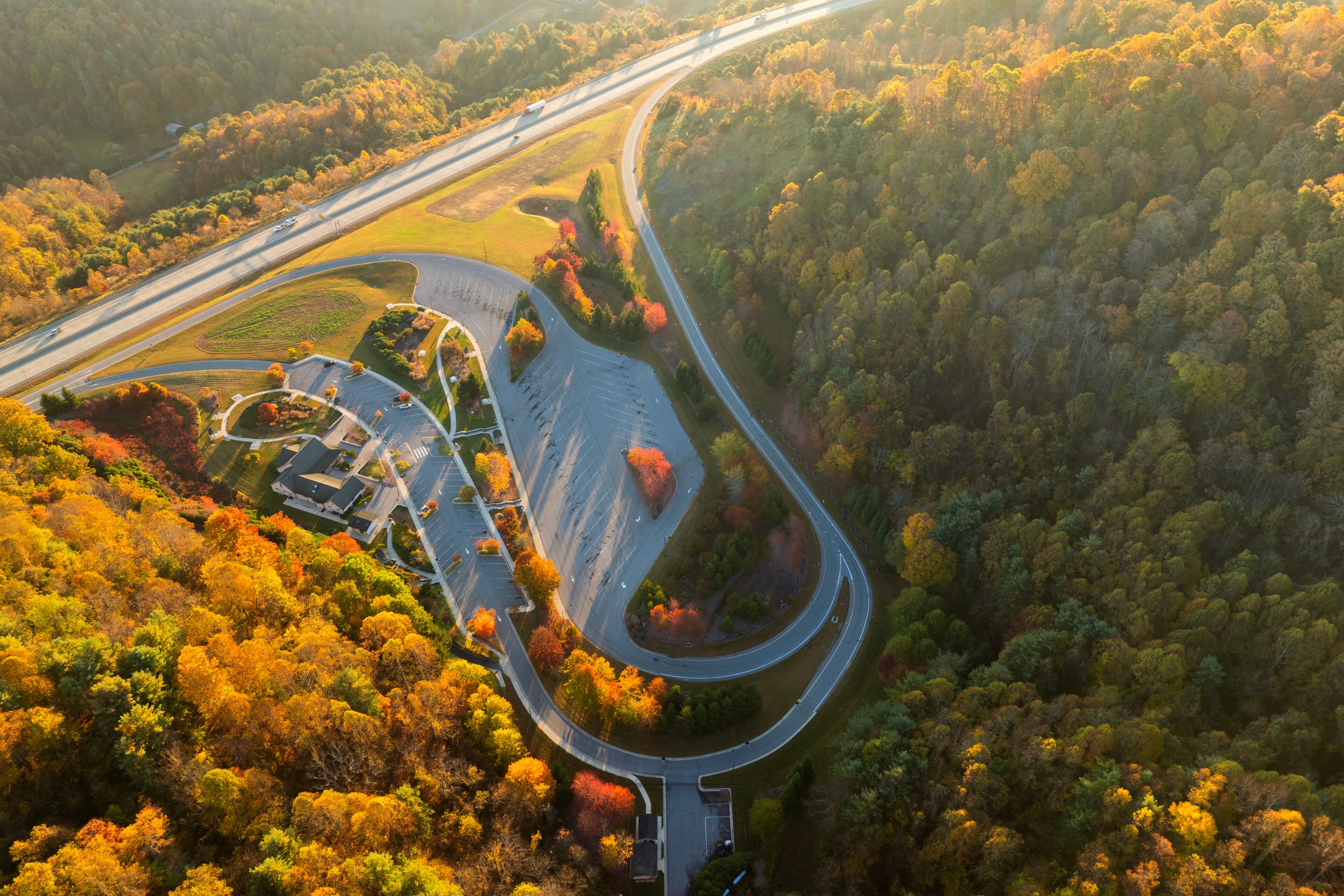 Aerial view of 4 Beech Glenn Parking rest area near busy I-26 American interstate freeway with fast moving cars and trucks. Recreational place between Appalachian hills during vacation travel concept