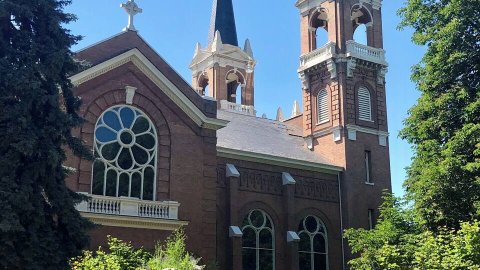 Located on the campus of Gonzaga University, the present St. Aloysius church was dedicated October 12, 1911. It has the largest seating capacity among Catholic churches in Spokane, able to accommodate 1,100 worshipers. The church, which replaced an original wooden structure, was designed by the architectural firm of Preusse & Zittle of Spokane. An adapted Romanesque style, its many rounded arches and graceful circular features help to soften construction lines. The church, begun in 1909, took almost exactly two years to build at a cost of $176,125.