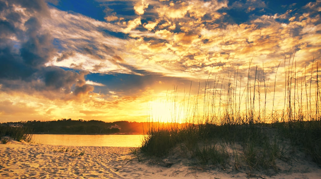 Sunset over the beach and dunes at Pawleys Island, SC, USA, looking across the inlet to the mainland.