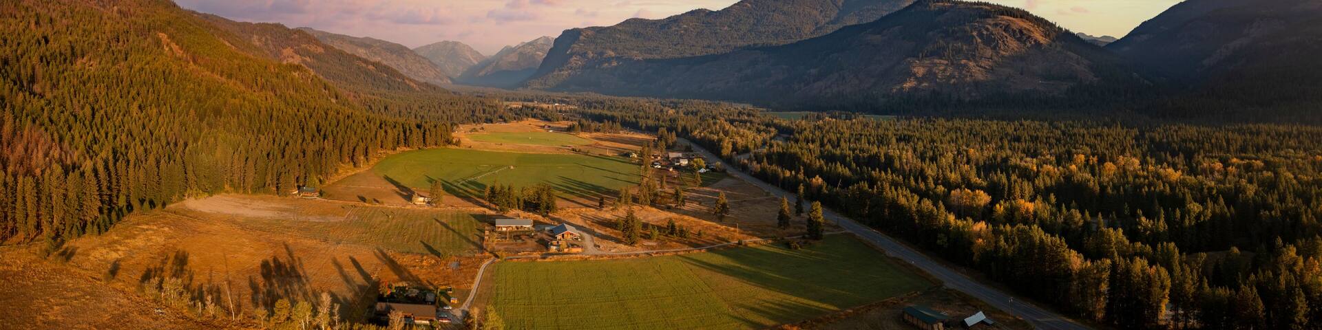 Aerial Panoramic View of the Historic Methow Valley in Eastern Washington State. Farm and ranch land lead to the North Cascade Mountains in this stunning landscape photographed on an autumnal morning.