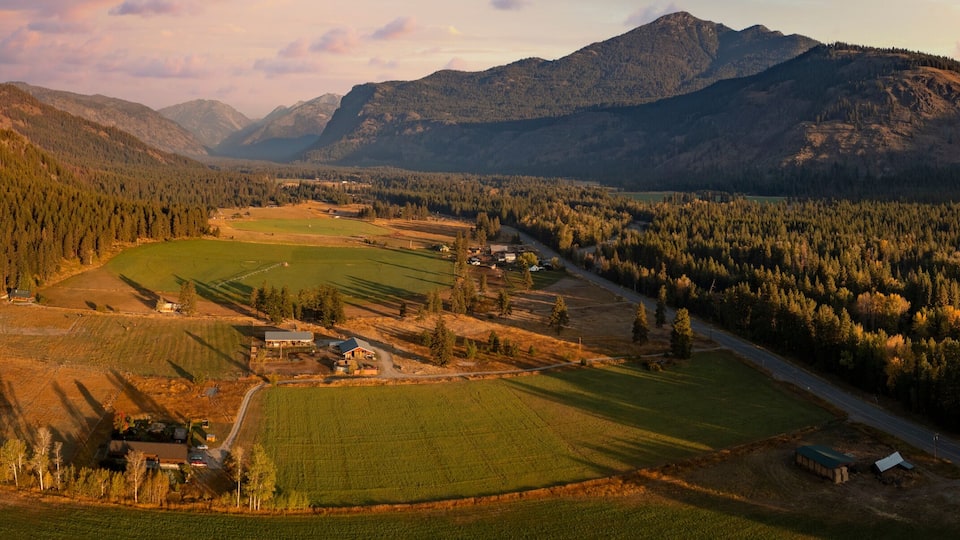 Aerial Panoramic View of the Historic Methow Valley in Eastern Washington State. Farm and ranch land lead to the North Cascade Mountains in this stunning landscape photographed on an autumnal morning.
