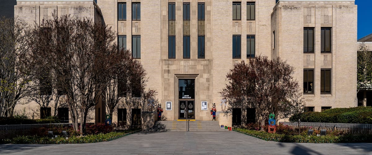The exterior of the Gregg County Court House with a clear blue sky.