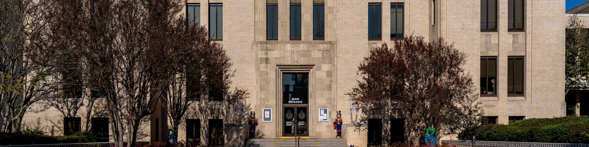 The exterior of the Gregg County Court House with a clear blue sky.