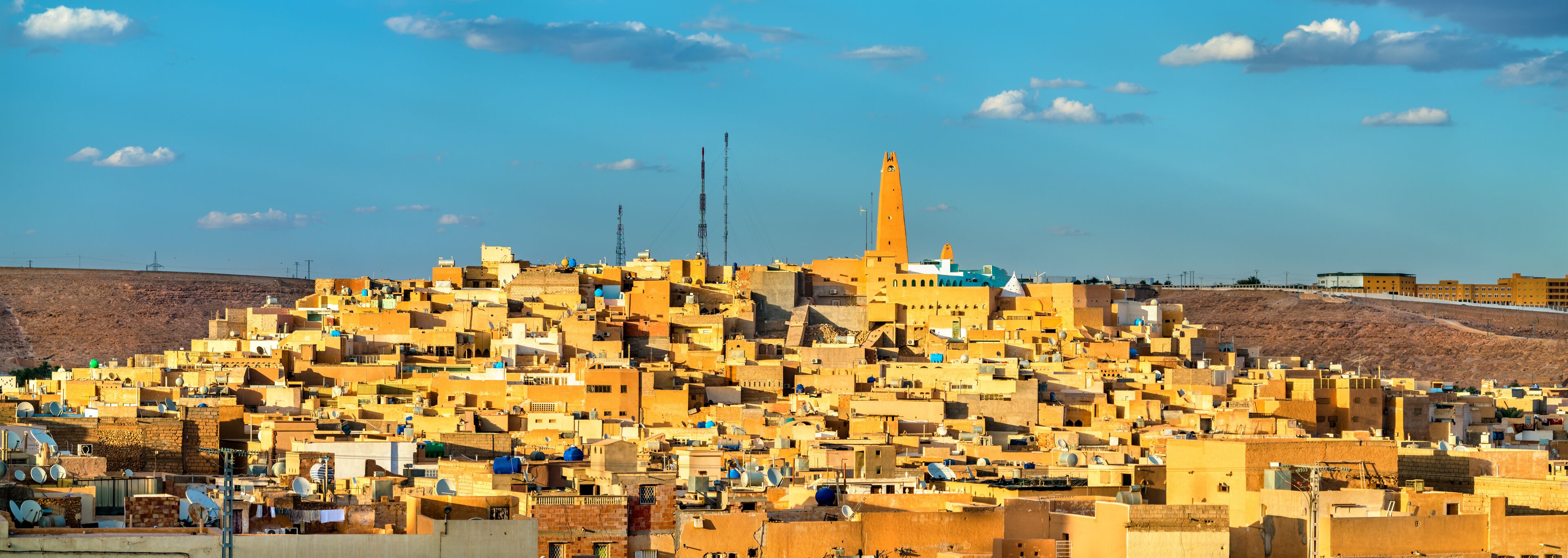 A densely packed urban area with numerous buildings and a prominent minaret.