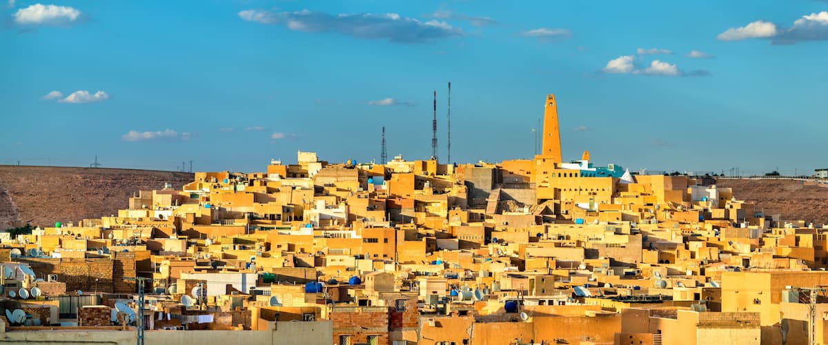 A densely packed urban area with numerous buildings and a prominent minaret.