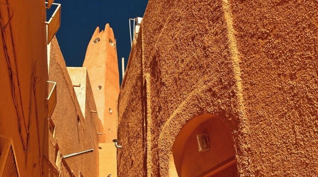 Ghardaia is the main of the five cities in the M'zab valley in Sahara, some 600 km south from Algiers and Medditeranean Sea. The cities of this pentapolis are Ghardaia (capital), Bounura, Beni Isguen (most sacred), Melika (main cemetery) and Al-Atteuf (oldest part) have walled centers (called Ksars) with a fortress-like mosque and minaret and storage in the centre on a hill surrounded by a maze of narrow streets and alleys and standartized cubical houses constructed in concentric circles aroung the mosque and hill. The place was founded by the Mozabites. These were of Berber origin and in 11th centure they were defeated by Fatimids in north and found a safe refuge far from their enemies in the canyons. Ironically the have quite soon converted to the religion of their enemies so the major population is now of the Ibadi Islam sect (another major Ibadi religion places are Oman and Zanzibar). However the isolation of the communities is still present in the defense-based architecture of ksars. The palm grove oases are surrounding the ksars using the river beds of the canyon valley.
The picture shows the street near the main mosque in Ksar of Ghardaia.
A UNESCO World Heritage Site since 1982.