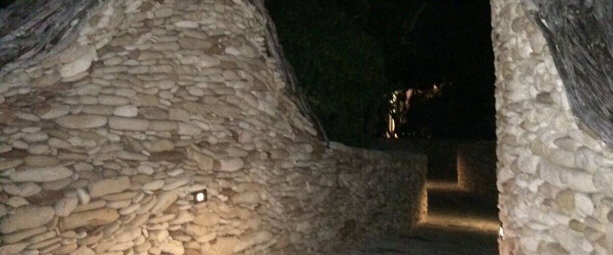 A stone archway with a staircase leading up to it.